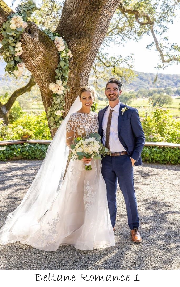 brinde and groom under decorated oak tree