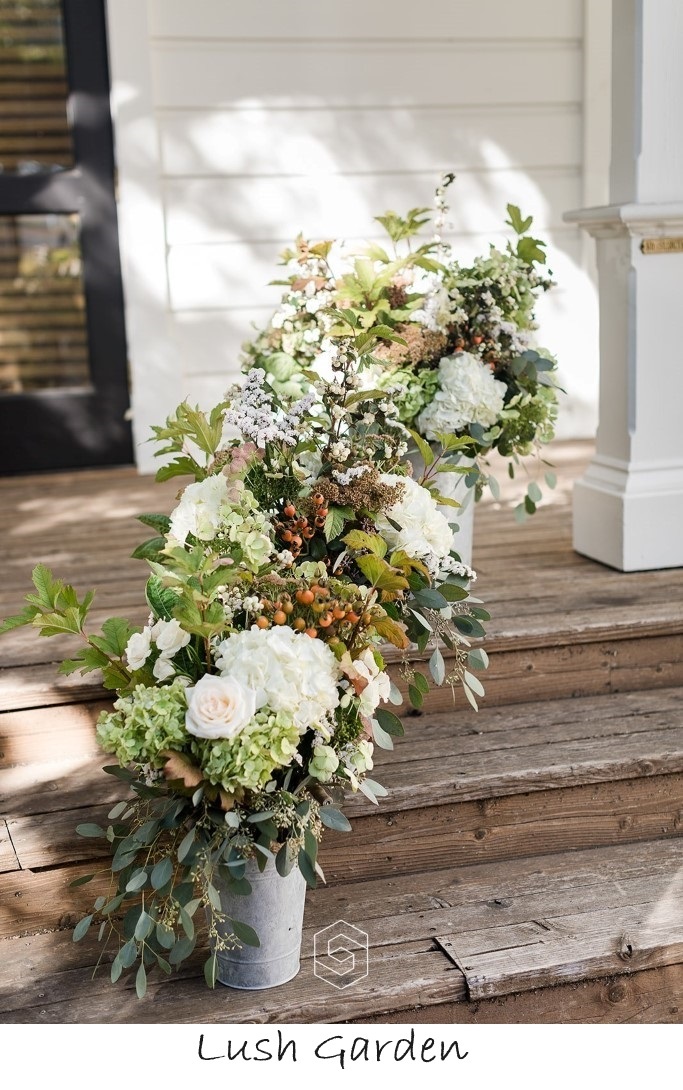 arrangements in galvanized buckets on wooden steps